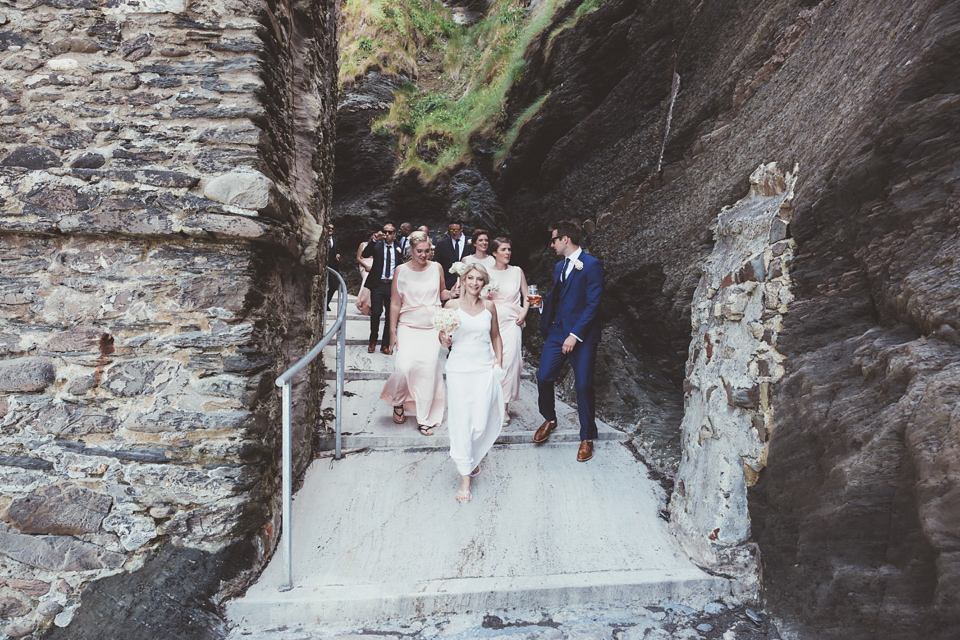 Charlotte wears a Charlotte Simpson gown for her wedding by the sea in Devon. Photography by Philippa James.