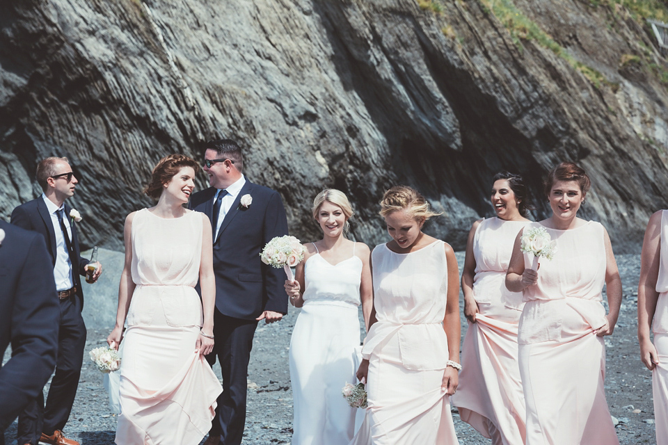 Charlotte wears a Charlotte Simpson gown for her wedding by the sea in Devon. Photography by Philippa James.