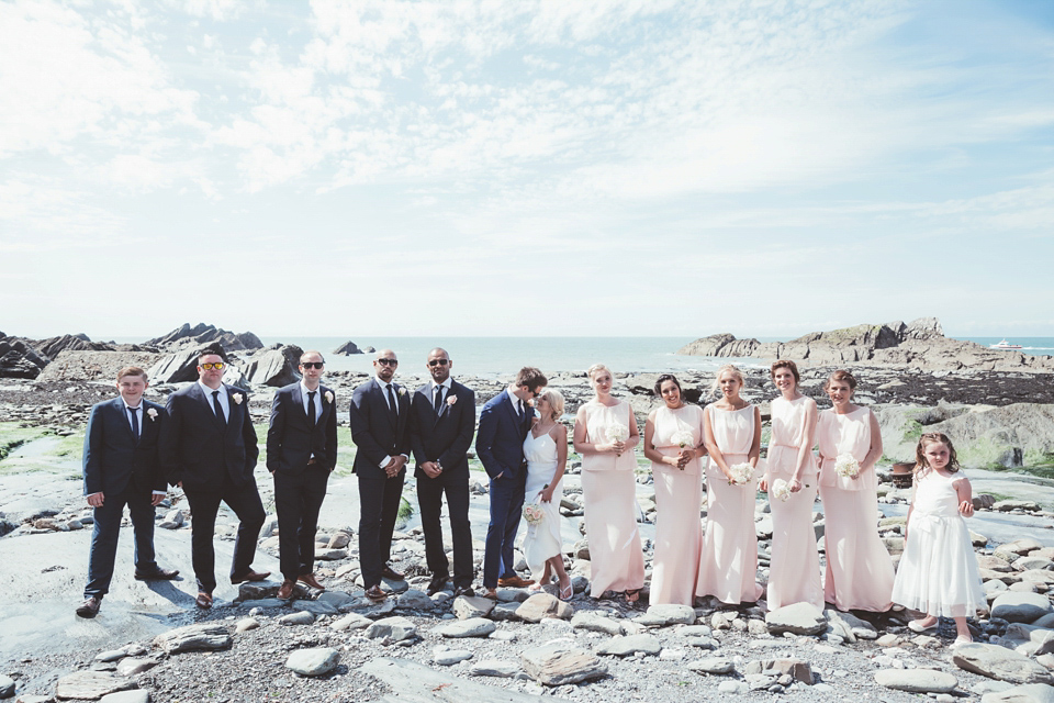 Charlotte wears a Charlotte Simpson gown for her wedding by the sea in Devon. Photography by Philippa James.