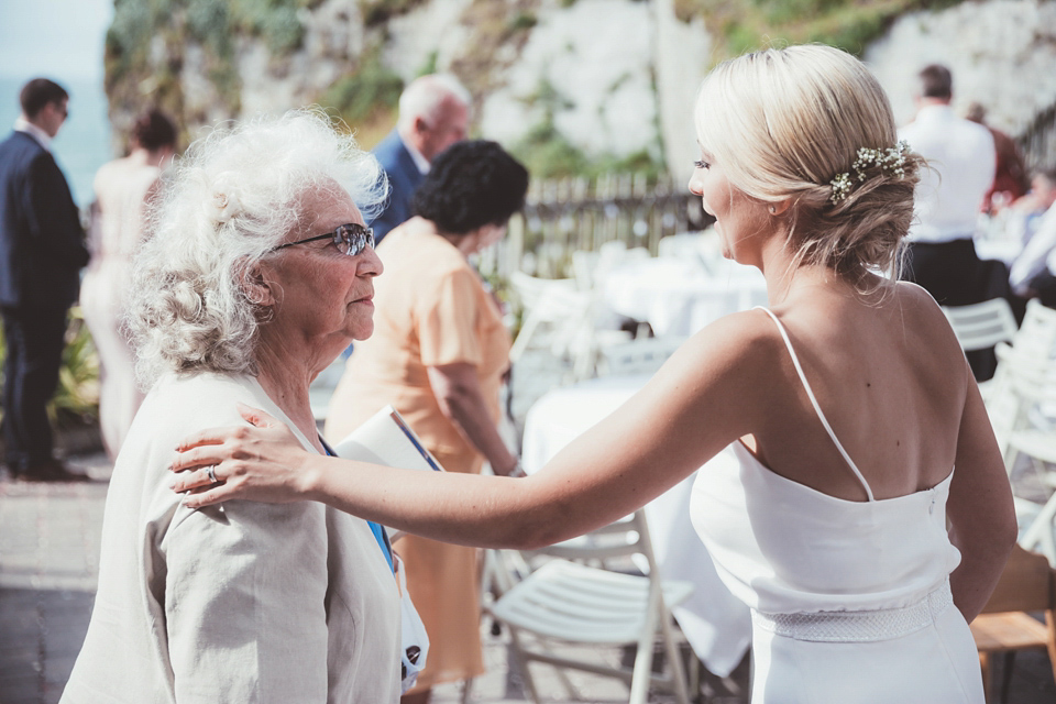 Charlotte wears a Charlotte Simpson gown for her wedding by the sea in Devon. Photography by Philippa James.