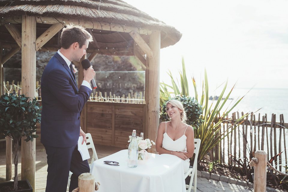 Charlotte wears a Charlotte Simpson gown for her wedding by the sea in Devon. Photography by Philippa James.