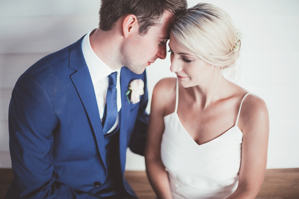 Charlotte wears a Charlotte Simpson gown for her wedding by the sea in Devon. Photography by Philippa James.