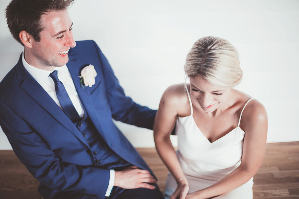 Charlotte wears a Charlotte Simpson gown for her wedding by the sea in Devon. Photography by Philippa James.