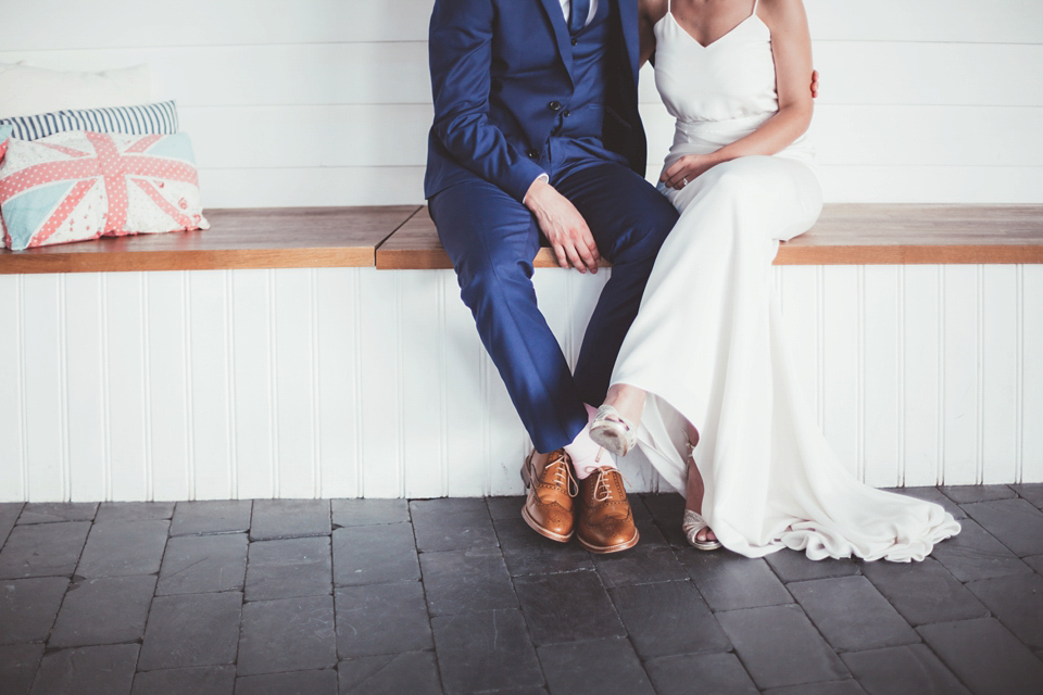 Charlotte wears a Charlotte Simpson gown for her wedding by the sea in Devon. Photography by Philippa James.