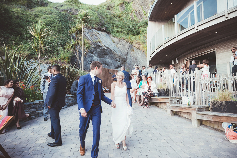 Charlotte wears a Charlotte Simpson gown for her wedding by the sea in Devon. Photography by Philippa James.