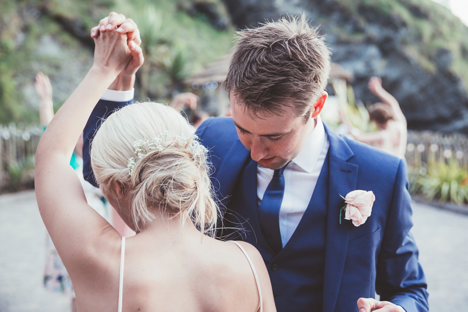 Charlotte wears a Charlotte Simpson gown for her wedding by the sea in Devon. Photography by Philippa James.