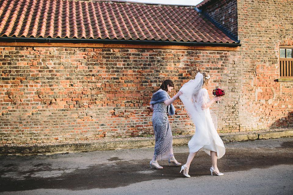 Laura wears 'Mimosa' by Jenny Packham for her winter wedding on the family farm in York. Photography by Kate Gray.