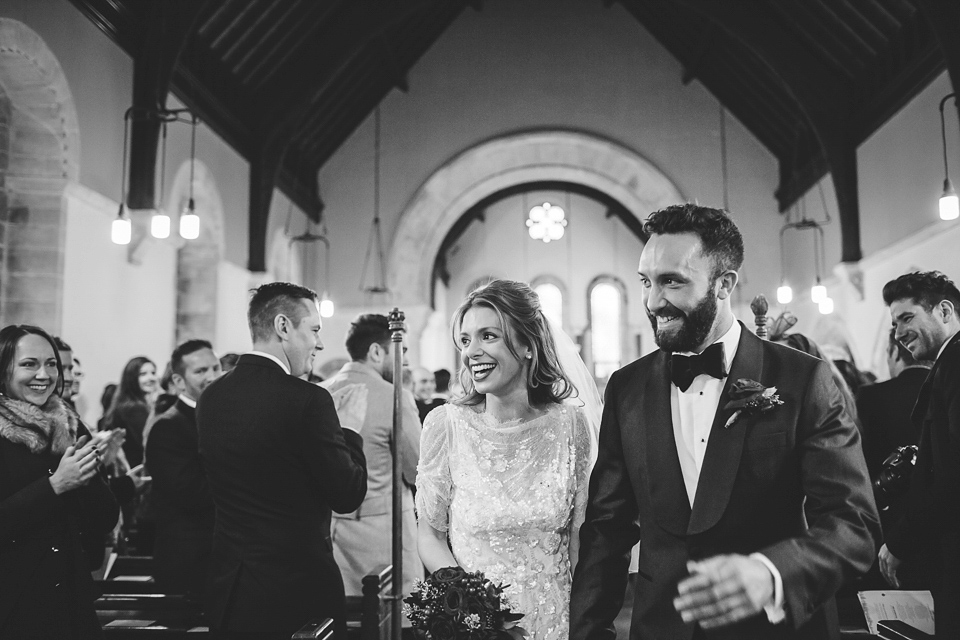 Laura wears 'Mimosa' by Jenny Packham for her winter wedding on the family farm in York. Photography by Kate Gray.