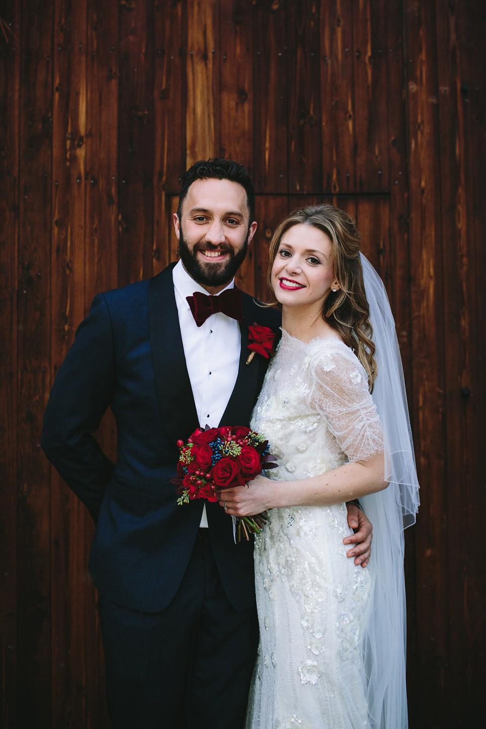 Laura wears 'Mimosa' by Jenny Packham for her winter wedding on the family farm in York. Photography by Kate Gray.