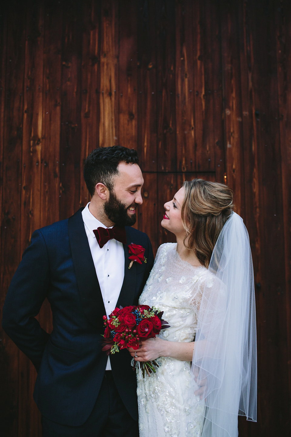 Laura wears 'Mimosa' by Jenny Packham for her winter wedding on the family farm in York. Photography by Kate Gray.