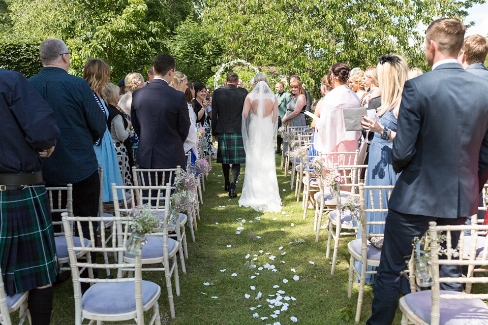 An Essense of Australia dress for a homespun, outdoor, country wedding in pretty pastel shades. Photography by Julie Tinton.