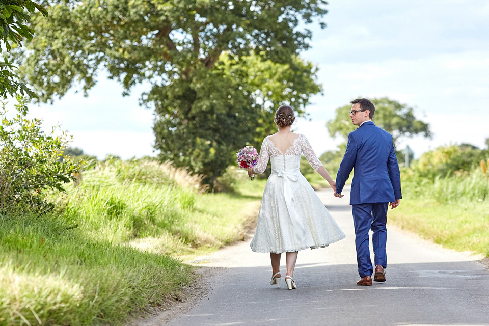 A fabulous 1950's Fur Coat No Knickers dress for a flower-filled Norfolk countryside wedding. Images by Fuller Photography.