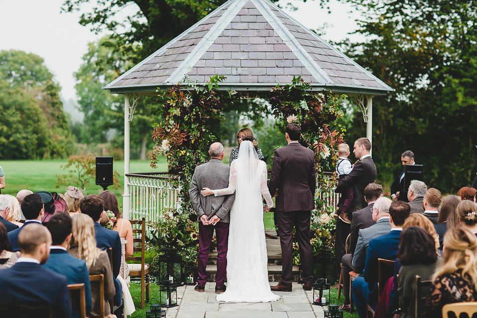 Bride Abby wears a gown by Wilden Bride of London for her Autumn wedding at Lemore Manor in Herefordshire. Photography by Sarah Beth, flowers by Juliet Glaves.