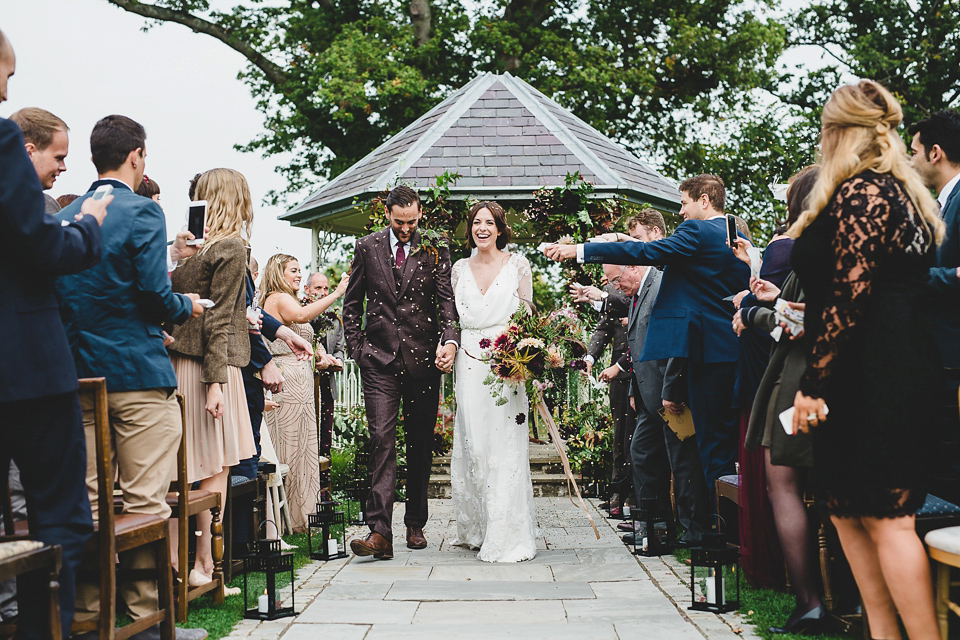 Bride Abby wears a gown by Wilden Bride of London for her Autumn wedding at Lemore Manor in Herefordshire. Photography by Sarah Beth, flowers by Juliet Glaves.