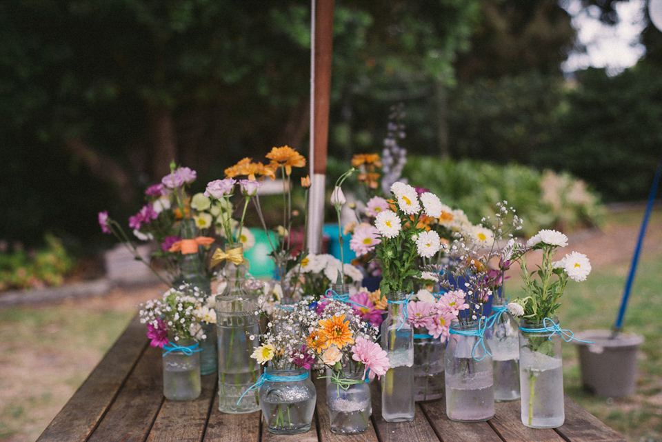 A blue sequin wedding dress for a colourful and flower filled picnic wedding. Photography by Sarah Burton.