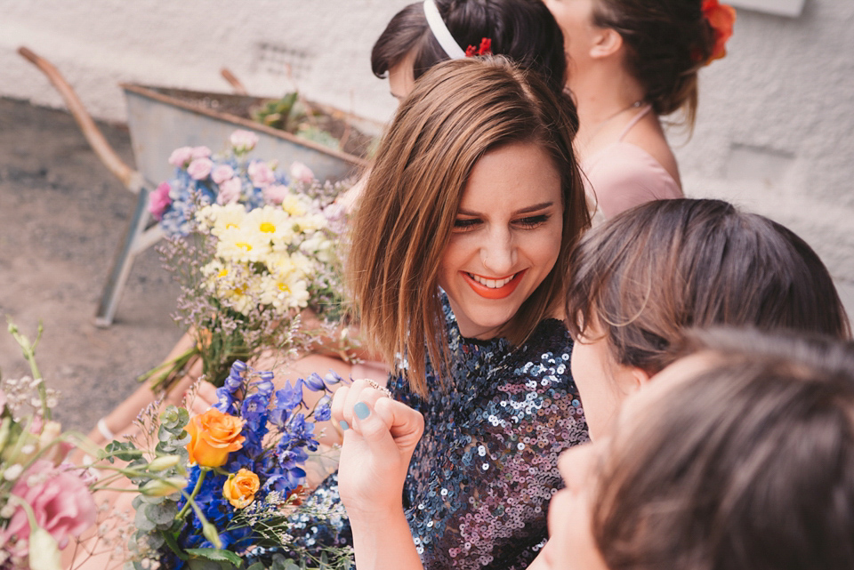 A blue sequin wedding dress for a colourful and flower filled picnic wedding. Photography by Sarah Burton.