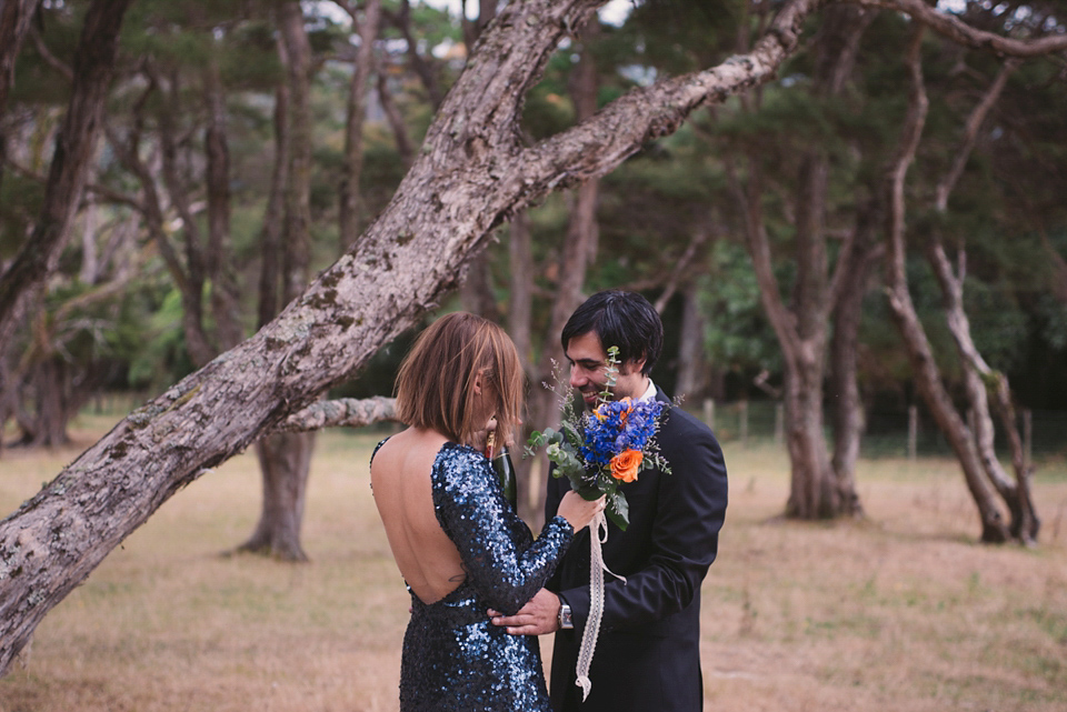 A blue sequin wedding dress for a colourful and flower filled picnic wedding. Photography by Sarah Burton.