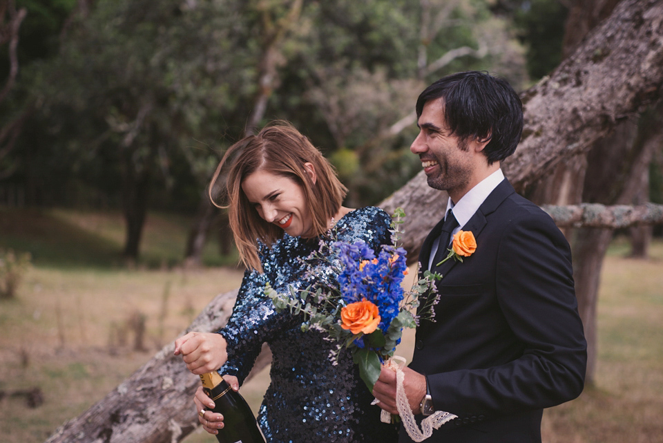 A blue sequin wedding dress for a colourful and flower filled picnic wedding. Photography by Sarah Burton.