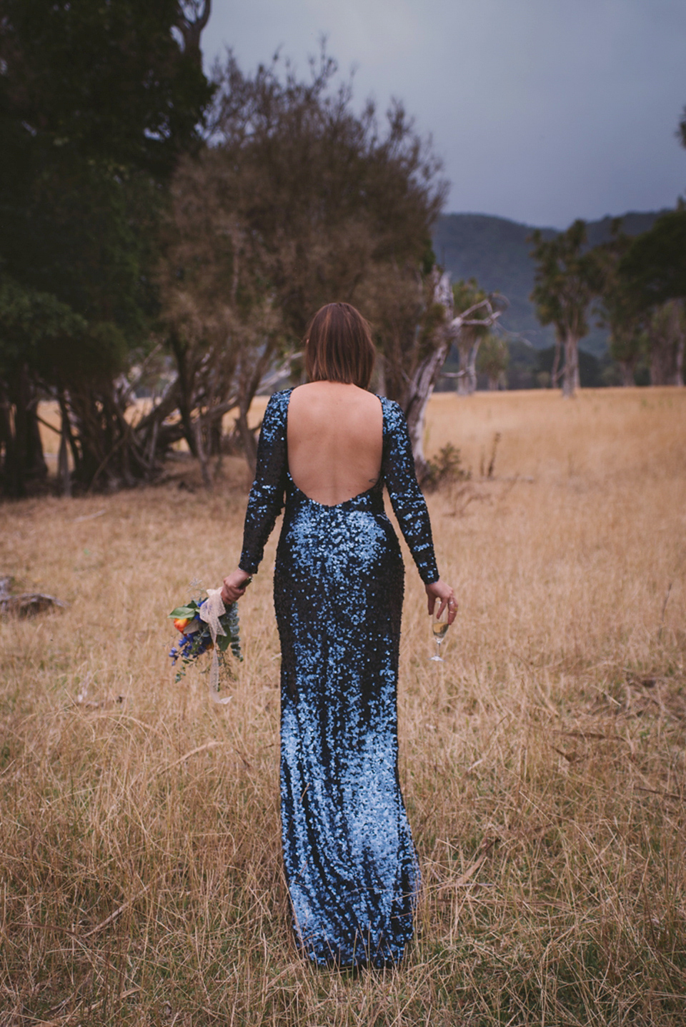 A blue sequin wedding dress for a colourful and flower filled picnic wedding. Photography by Sarah Burton.