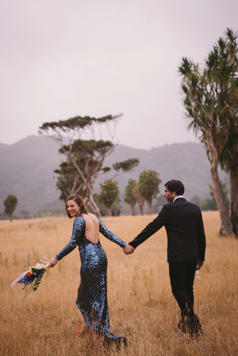 A blue sequin wedding dress for a colourful and flower filled picnic wedding. Photography by Sarah Burton.