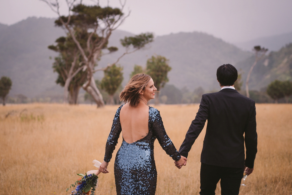 A blue sequin wedding dress for a colourful and flower filled picnic wedding. Photography by Sarah Burton.