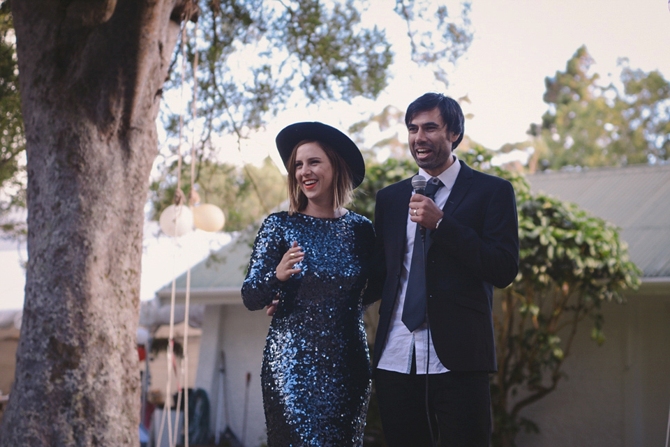 A blue sequin wedding dress for a colourful and flower filled picnic wedding. Photography by Sarah Burton.