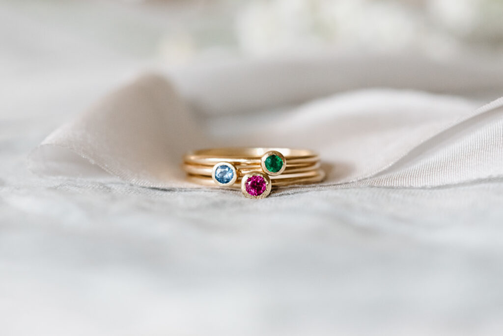 A set of teeny stacking rings with sapphire, ruby and emerald