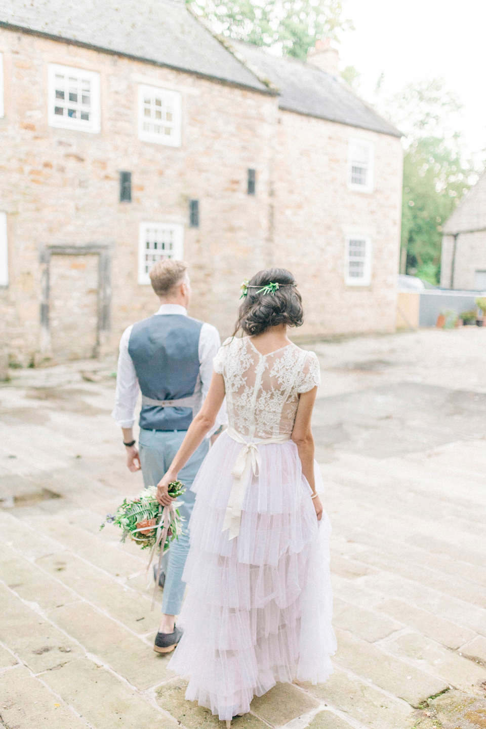 Bride Laura wore a tiered wedding dress by Katya Katya Shehurina for her peach wedding at Lartington Hall in Teesdale. Photography by Sarah Jane Ethan.