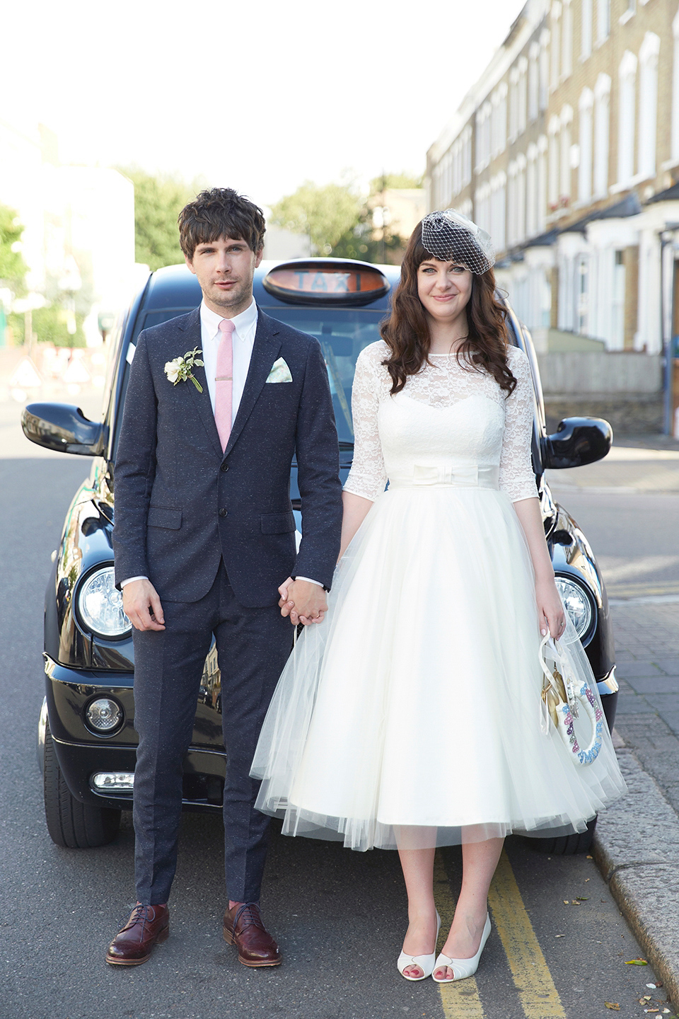 A 50's inspired tea-length dress for a pastel colour London pub wedding. Photography by Natalie J. Weddings.