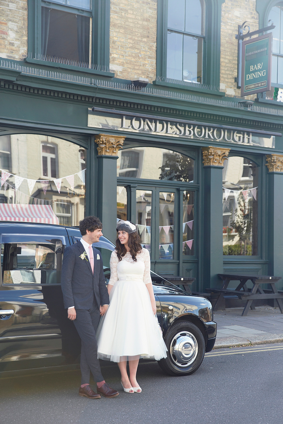 A 50's inspired tea-length dress for a pastel colour London pub wedding. Photography by Natalie J. Weddings.