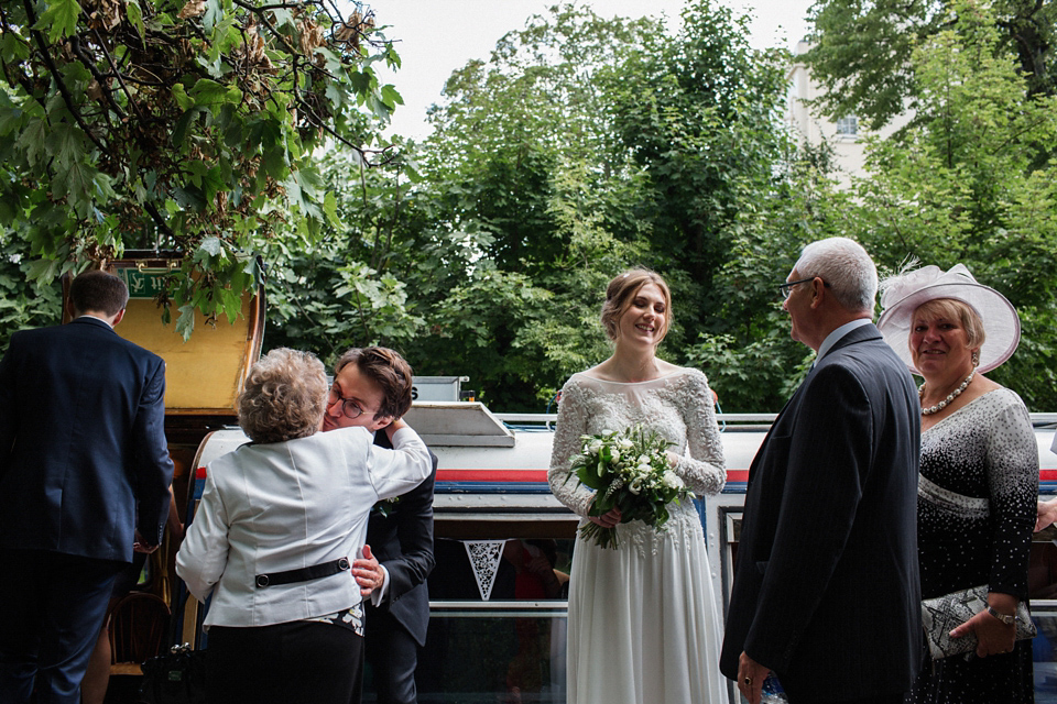 Victoria wears a backless, full-sleeved gown by Maria Senvo for her 1920's and Gatsby inspired London pub wedding. Photography by Hearts on Fire.