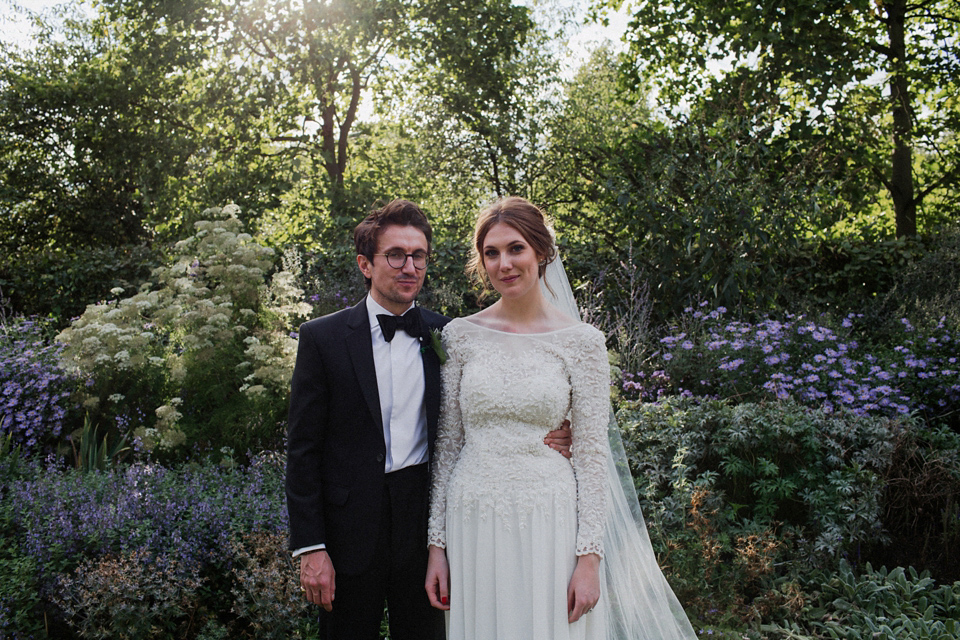 Victoria wears a backless, full-sleeved gown by Maria Senvo for her 1920's and Gatsby inspired London pub wedding. Photography by Hearts on Fire.