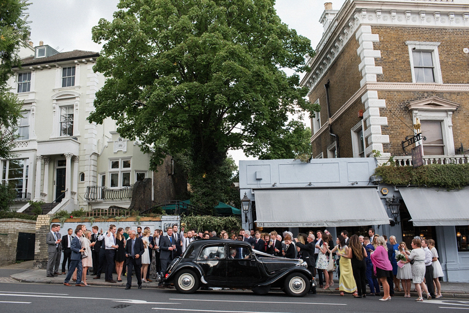 Victoria wears a backless, full-sleeved gown by Maria Senvo for her 1920's and Gatsby inspired London pub wedding. Photography by Hearts on Fire.