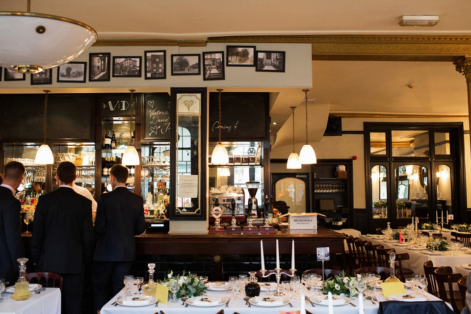 Victoria wears a backless, full-sleeved gown by Maria Senvo for her 1920's and Gatsby inspired London pub wedding. Photography by Hearts on Fire.