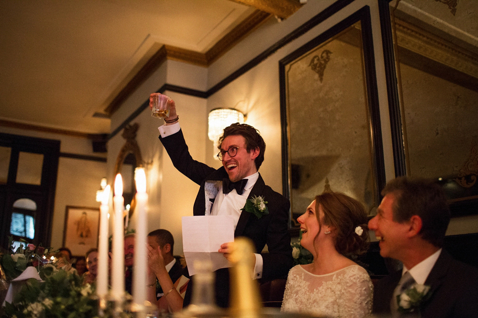 Victoria wears a backless, full-sleeved gown by Maria Senvo for her 1920's and Gatsby inspired London pub wedding. Photography by Hearts on Fire.