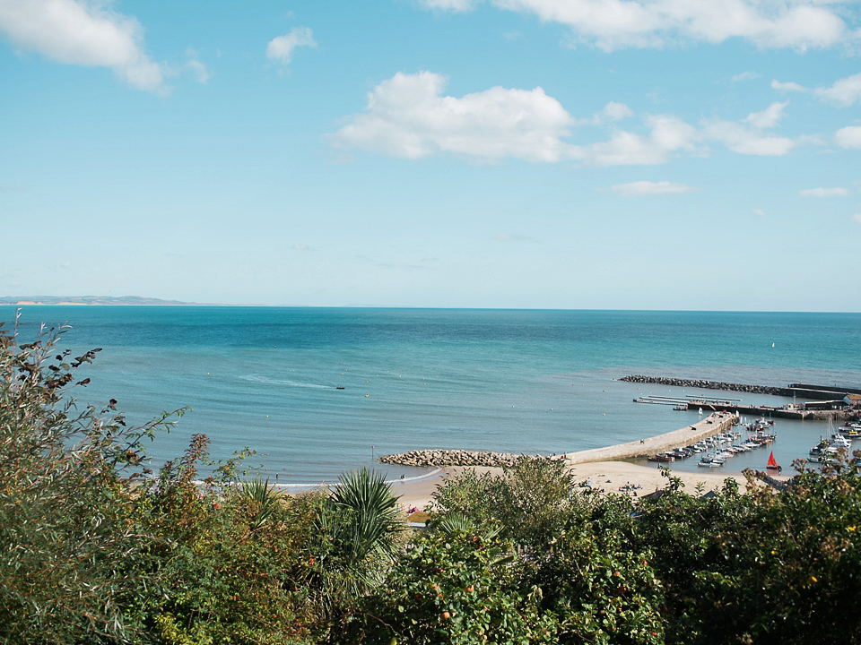 Verity wears a Halfpenny London gown for her garden party inspired wedding by the sea. Photography by John Barwood.