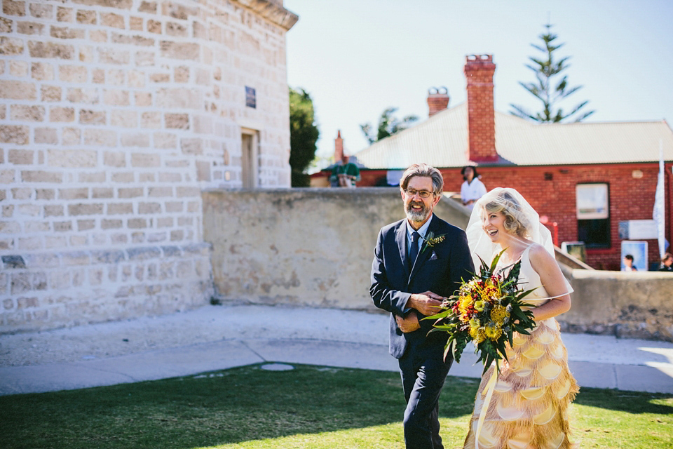 A 1920's flapper inspired wedding dress with tassels. Photography by Through The Woods We Ran.