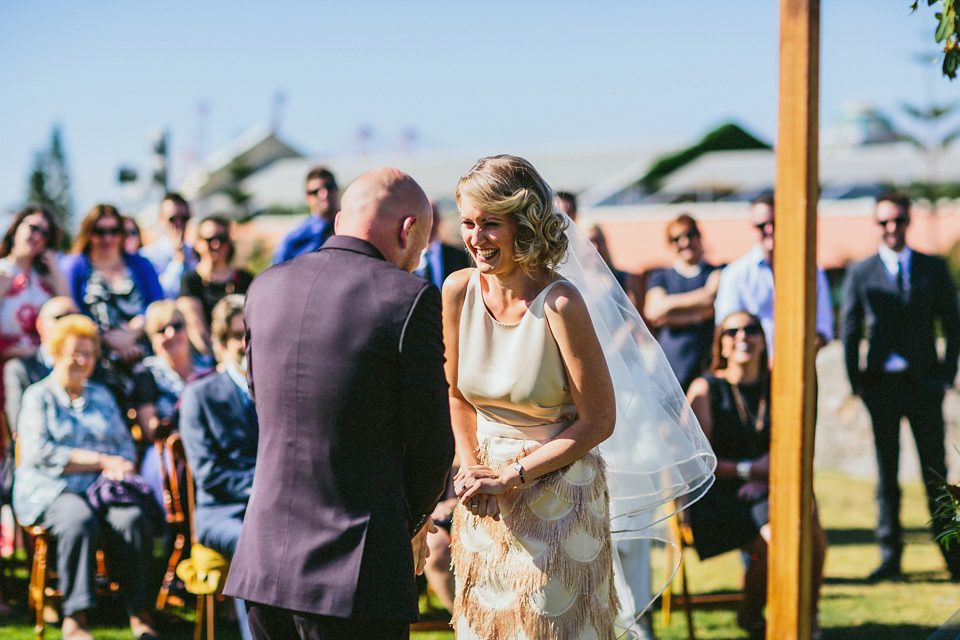 A 1920's flapper inspired wedding dress with tassels. Photography by Through The Woods We Ran.