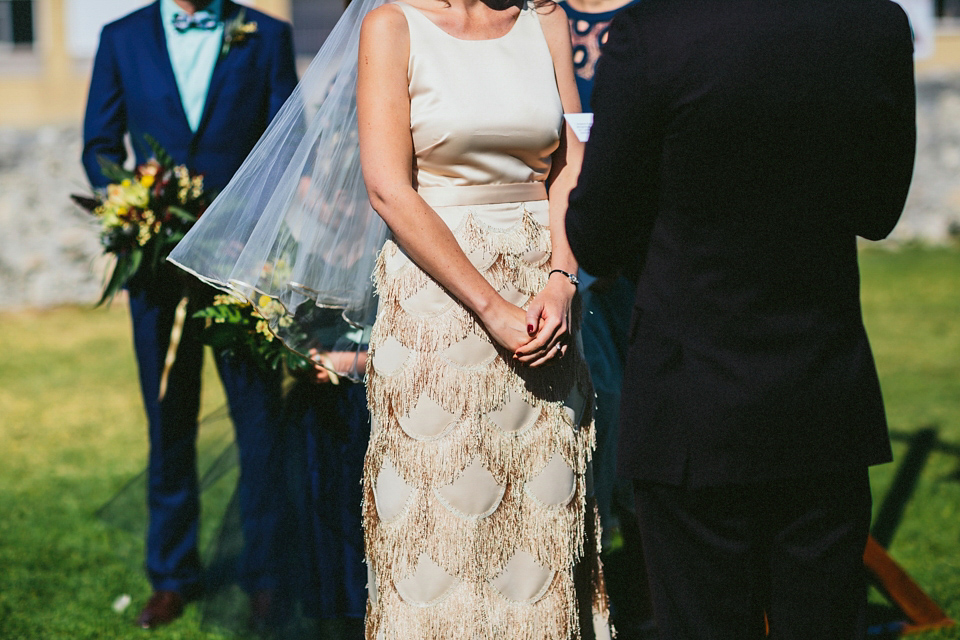 A 1920's flapper inspired wedding dress with tassels. Photography by Through The Woods We Ran.