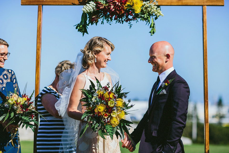 A 1920's flapper inspired wedding dress with tassels. Photography by Through The Woods We Ran.
