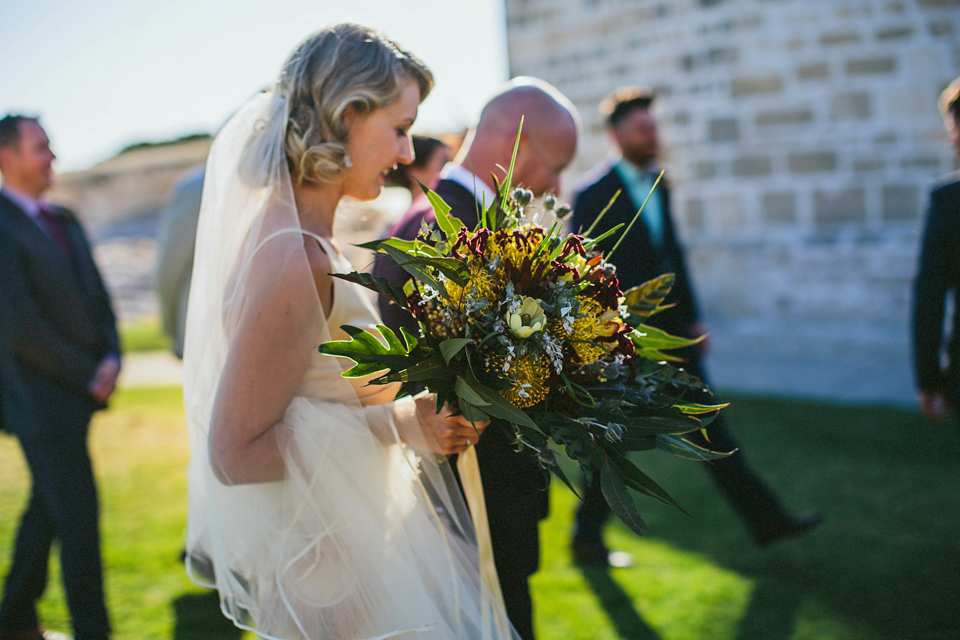 A 1920's flapper inspired wedding dress with tassels. Photography by Through The Woods We Ran.