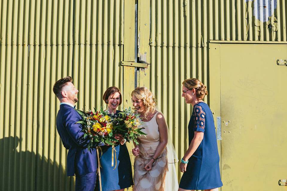 A 1920's flapper inspired wedding dress with tassels. Photography by Through The Woods We Ran.