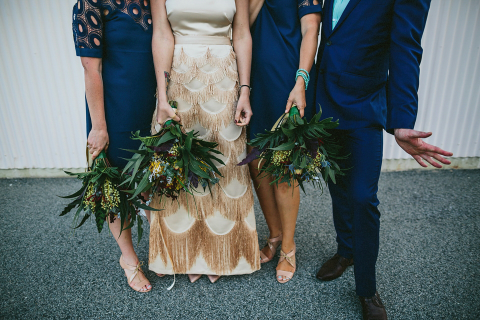 A 1920's flapper inspired wedding dress with tassels. Photography by Through The Woods We Ran.