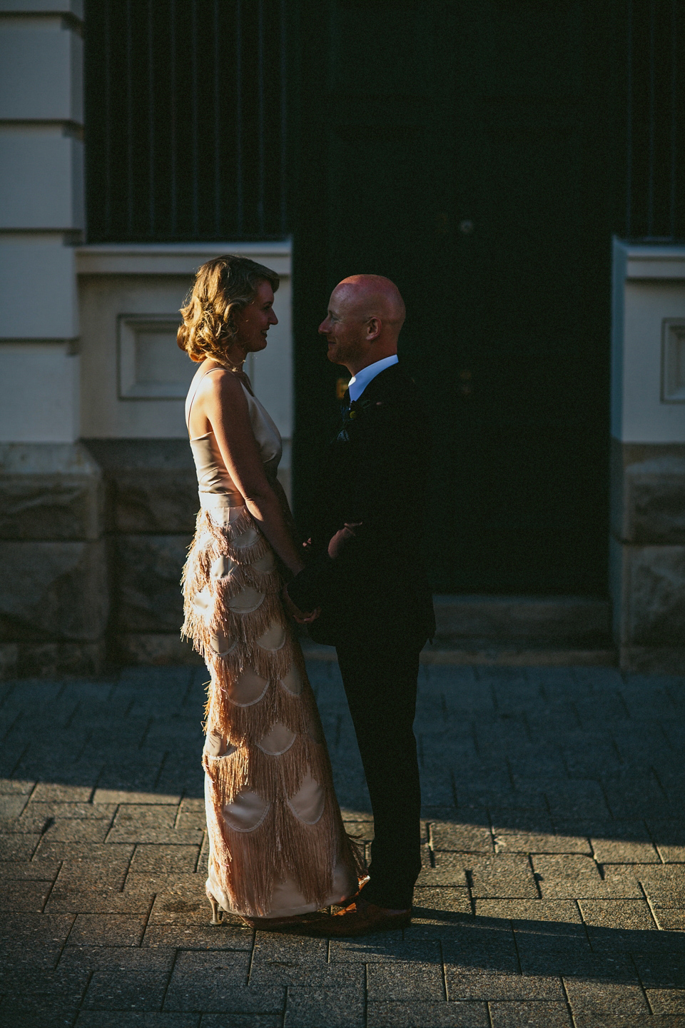 A 1920's flapper inspired wedding dress with tassels. Photography by Through The Woods We Ran.