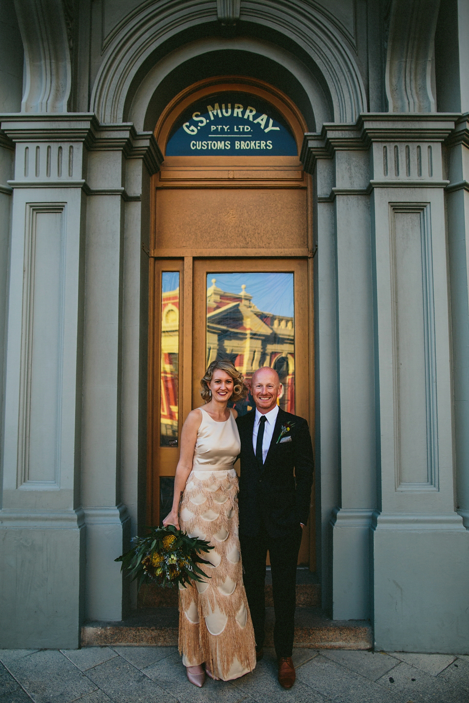 A 1920's flapper inspired wedding dress with tassels. Photography by Through The Woods We Ran.