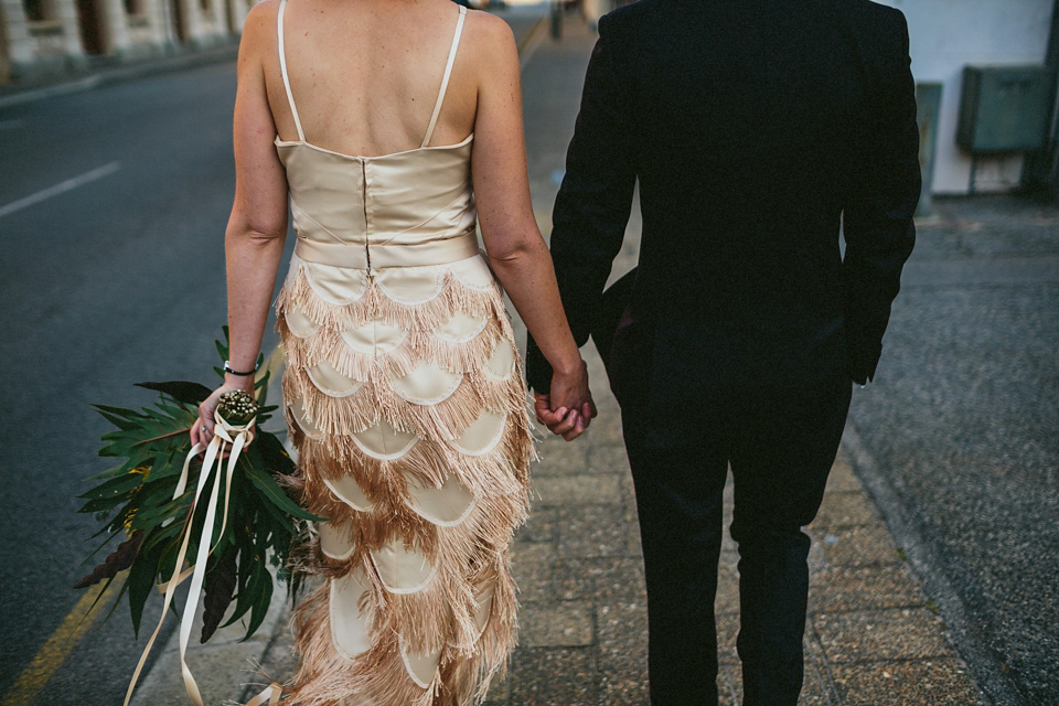 A 1920's flapper inspired wedding dress with tassels. Photography by Through The Woods We Ran.