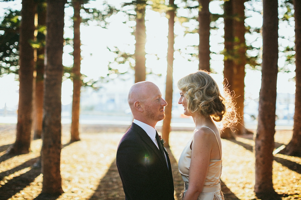 A 1920's flapper inspired wedding dress with tassels. Photography by Through The Woods We Ran.