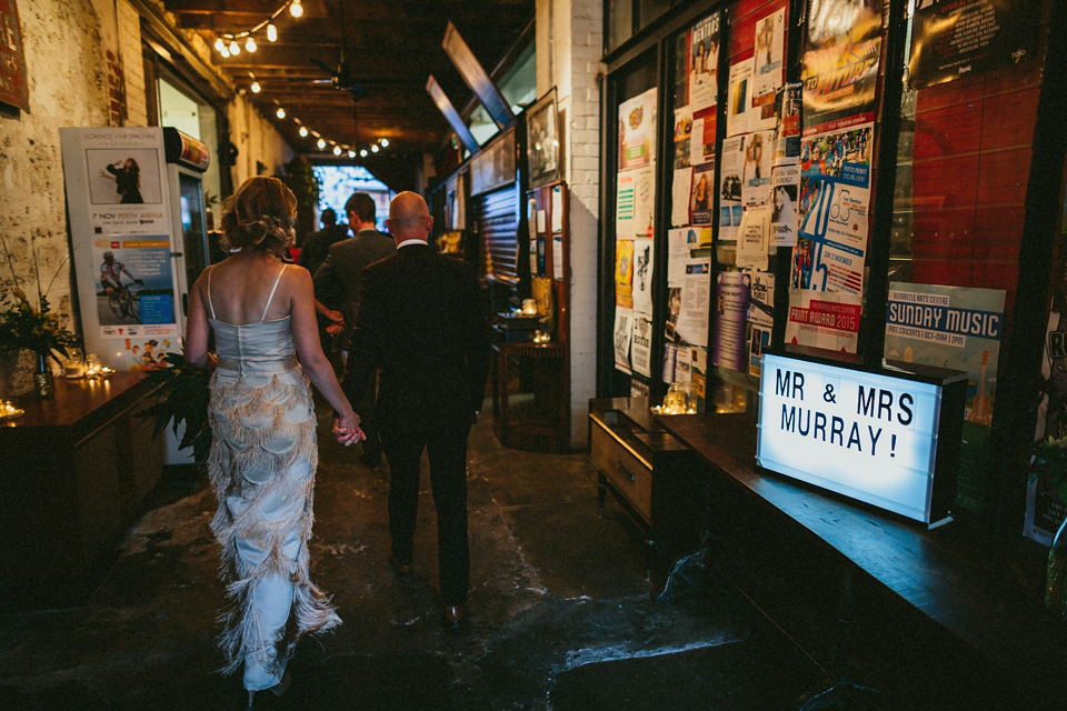 A 1920's flapper inspired wedding dress with tassels. Photography by Through The Woods We Ran.