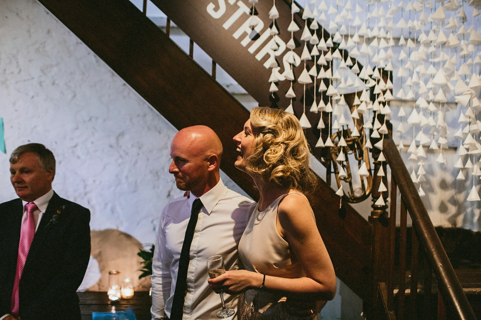 A 1920's flapper inspired wedding dress with tassels. Photography by Through The Woods We Ran.