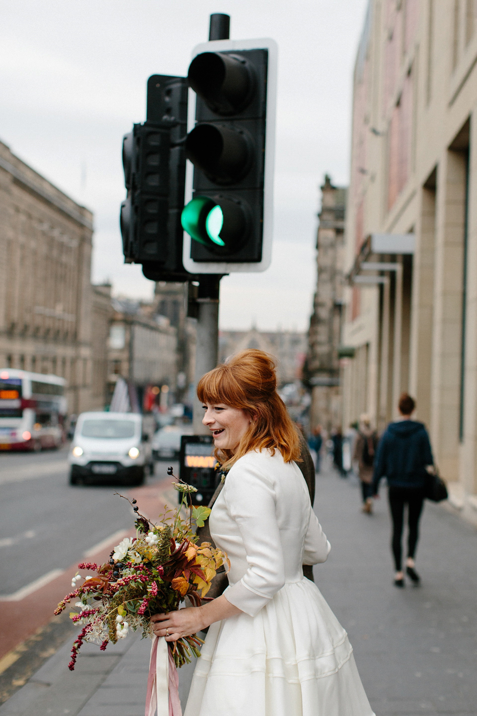 Lizzie wore a 1960's inspired short dress by Delphine Manivet for her intimate wedding in Edinburgh. Photography by Caro Weiss.